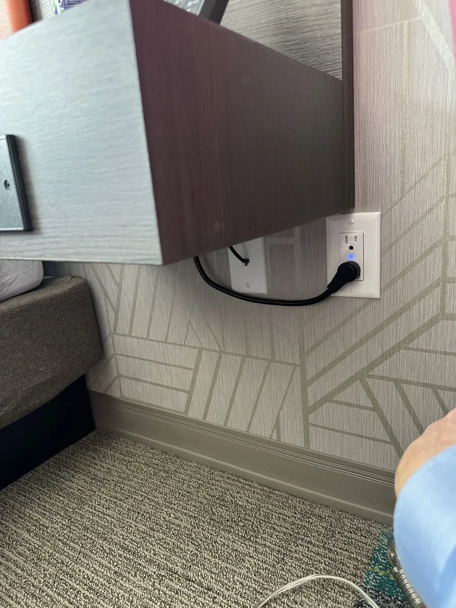 GridRabbit controlled outlet installed near a hotel bed