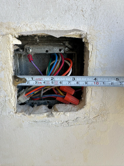 Renovation wall opening example showing what the thermostat beauty plate helps cover
